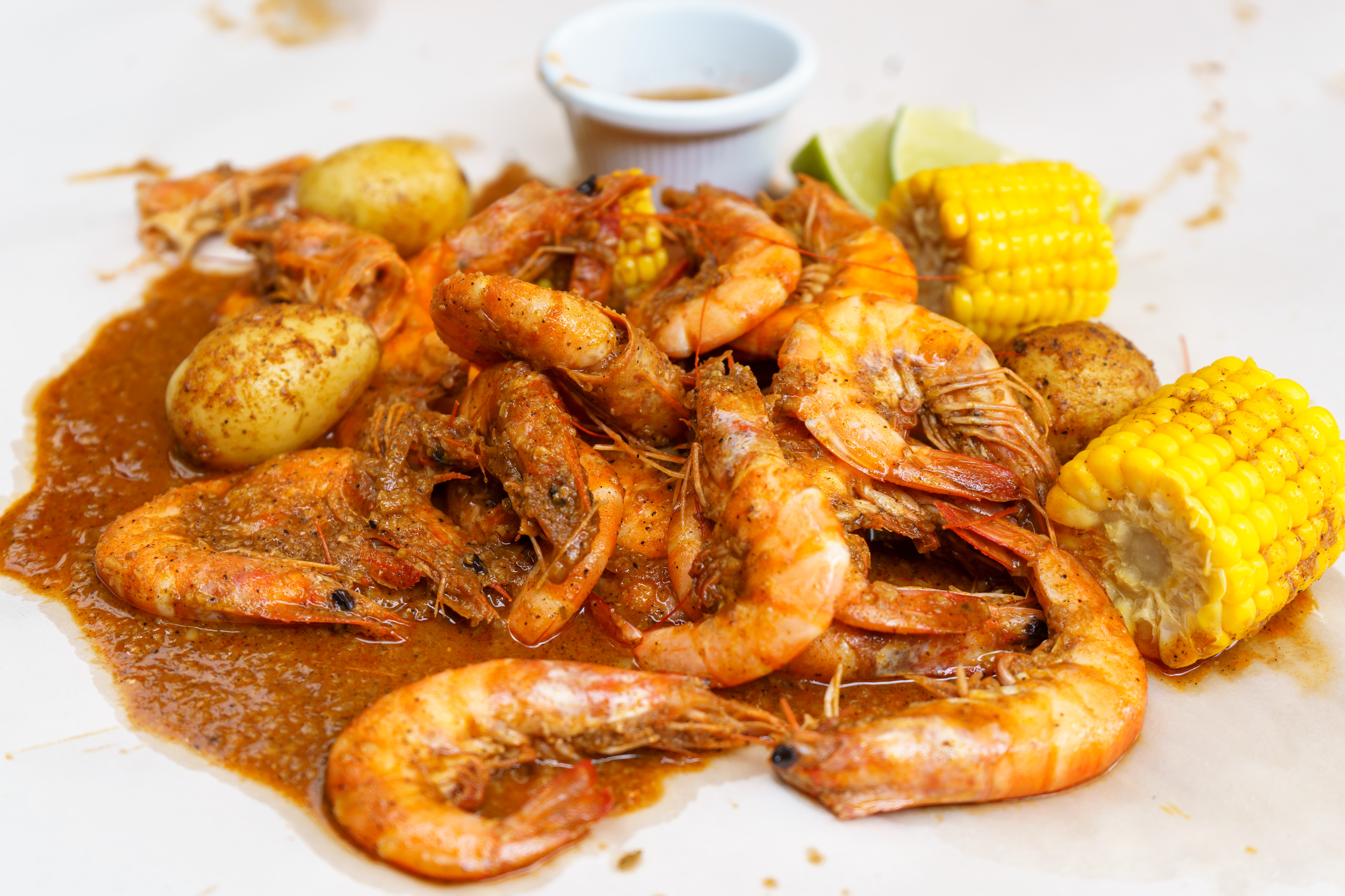 A vibrant Cajun shrimp boil with seasoned potatoes and corn, perfect for a seafood feast.