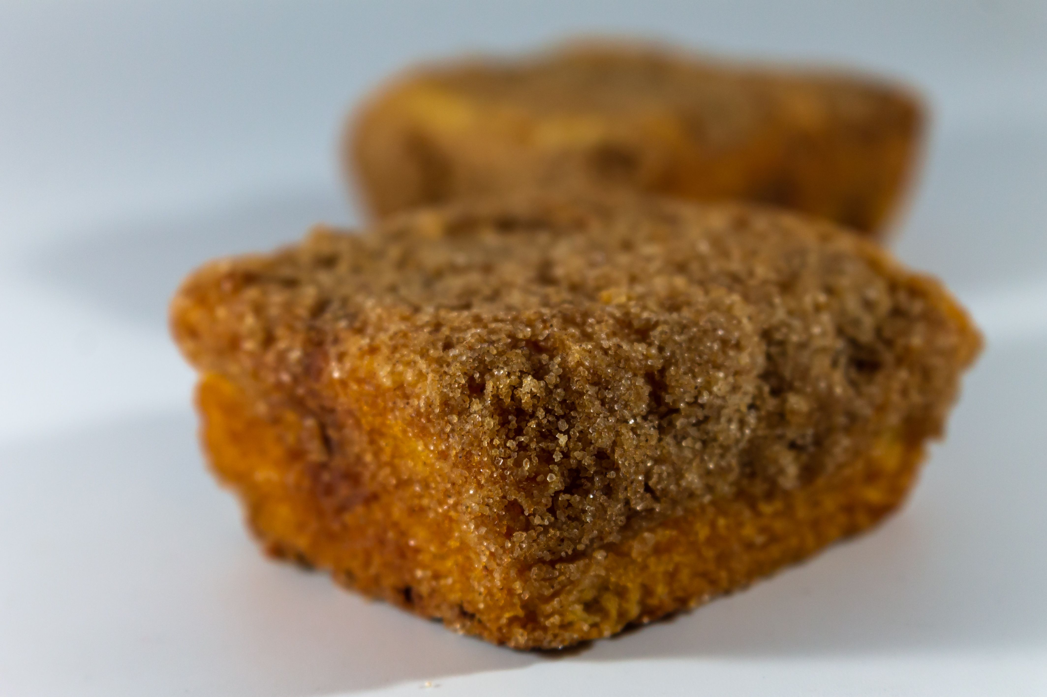 Delicious crumb-topped muffins captured in a close-up showcasing their texture and appeal.